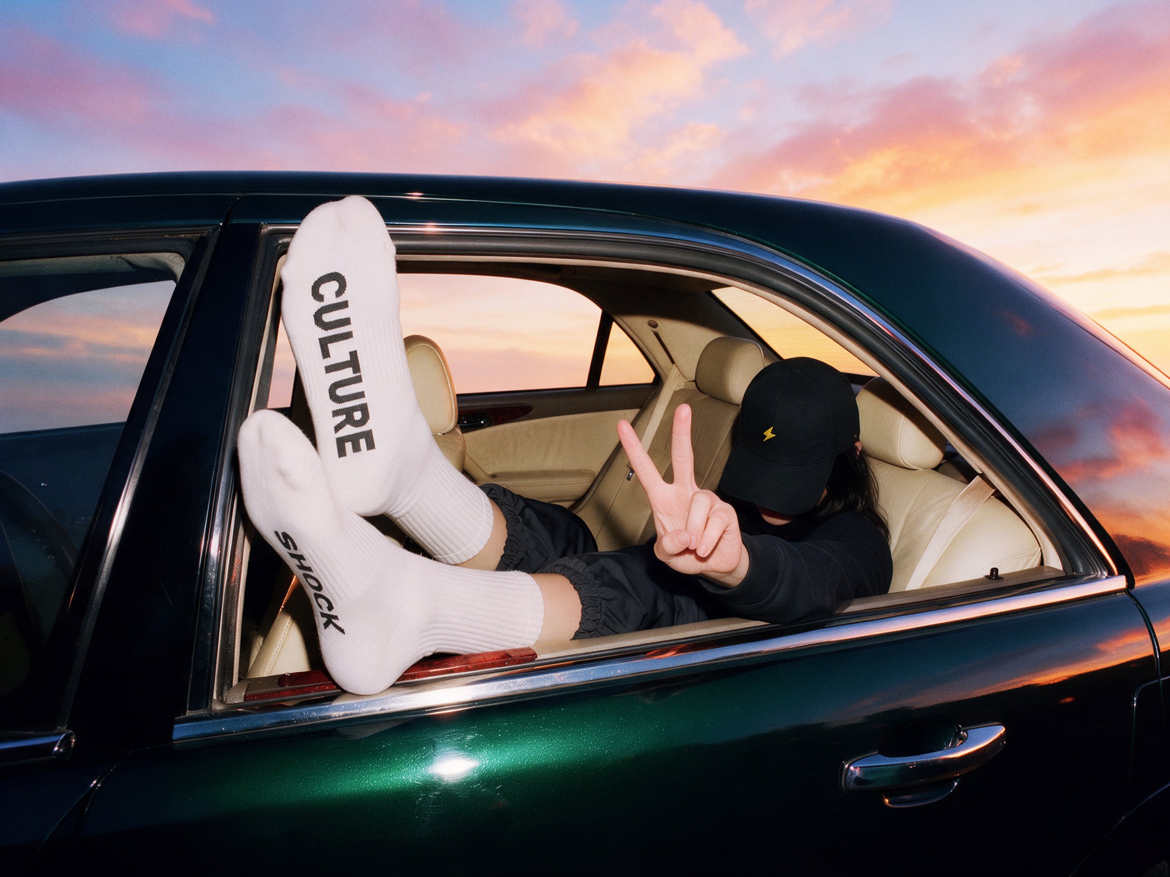 Figure leaning from a car with Culture Shock lettering
