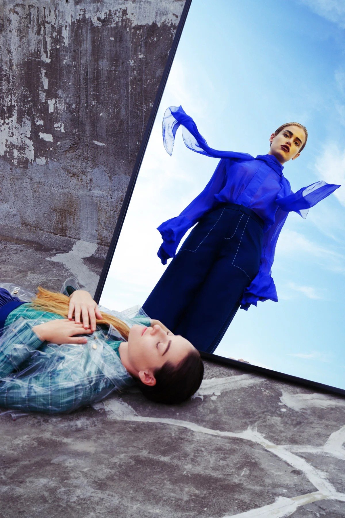 Figure in blue standing above a reclining figure