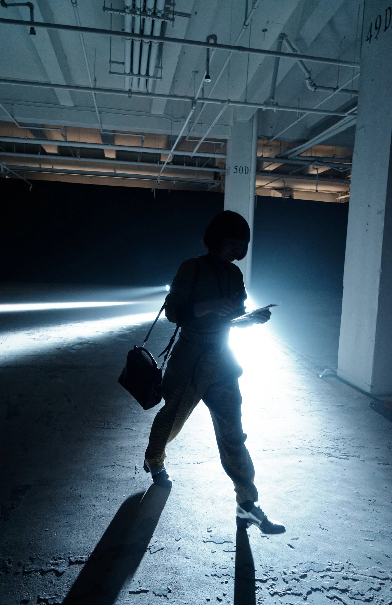 Silhouette crossing a light-filled runway