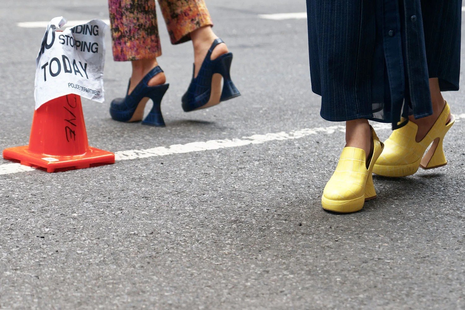 Close-up of bright yellow shoes on a street