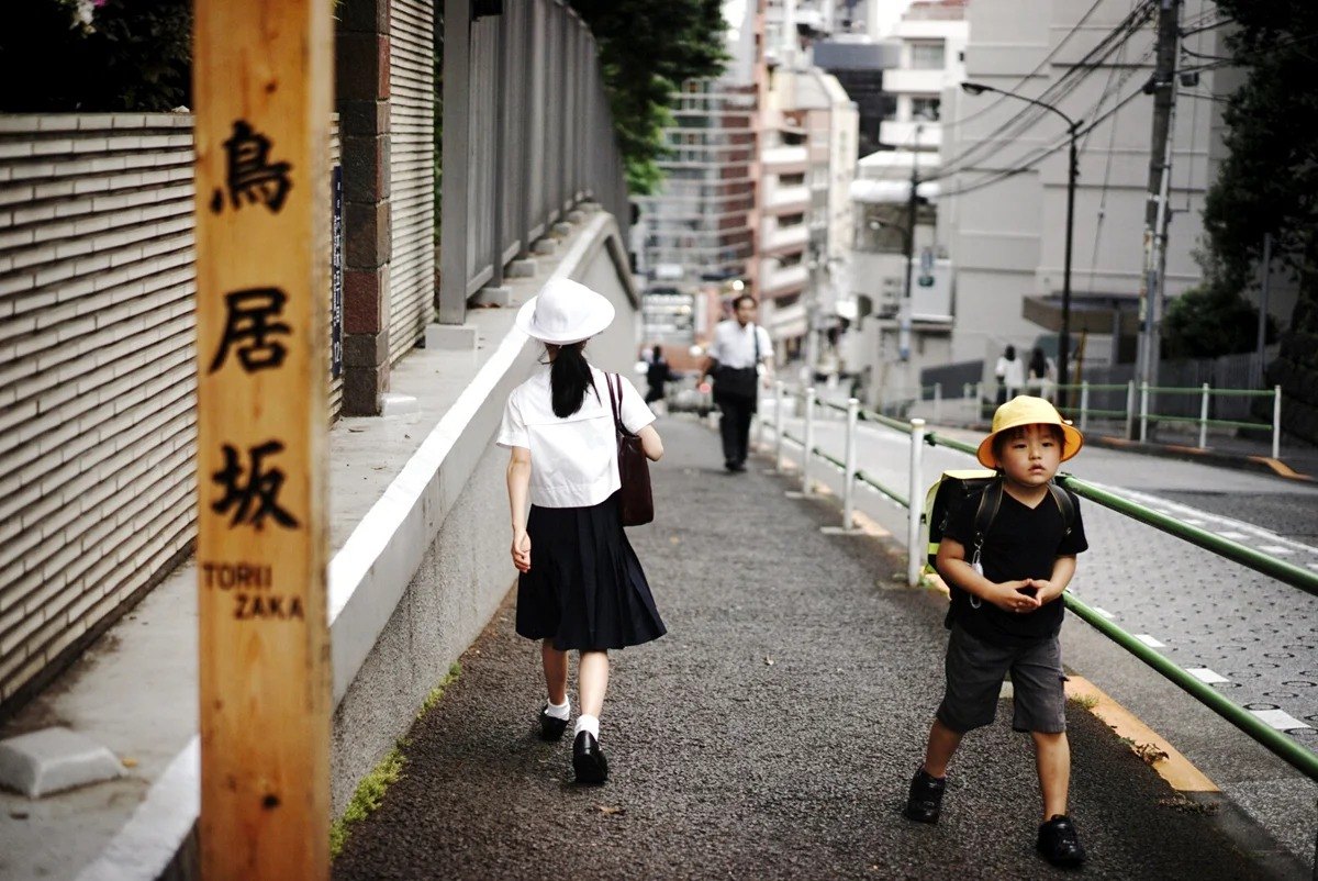 Two figures on a narrow urban street