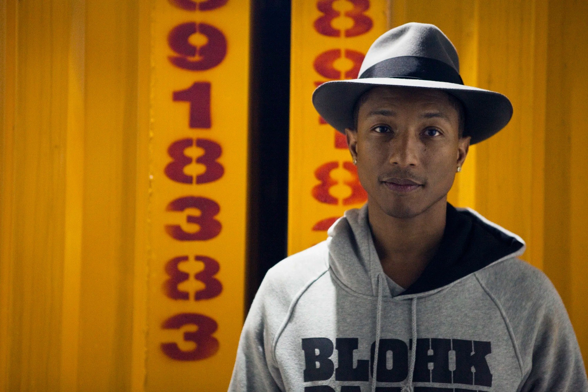 Portrait in a hat against a yellow wall