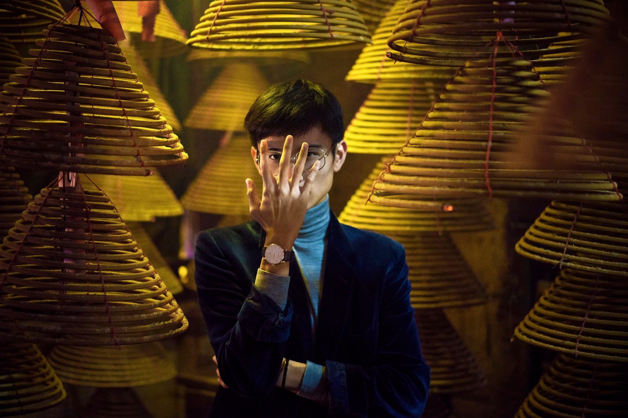 Portrait framed by gold architectural reflections