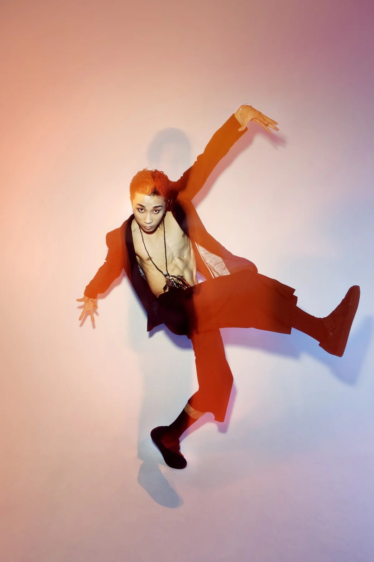 Figure in motion against a peach-coloured background
