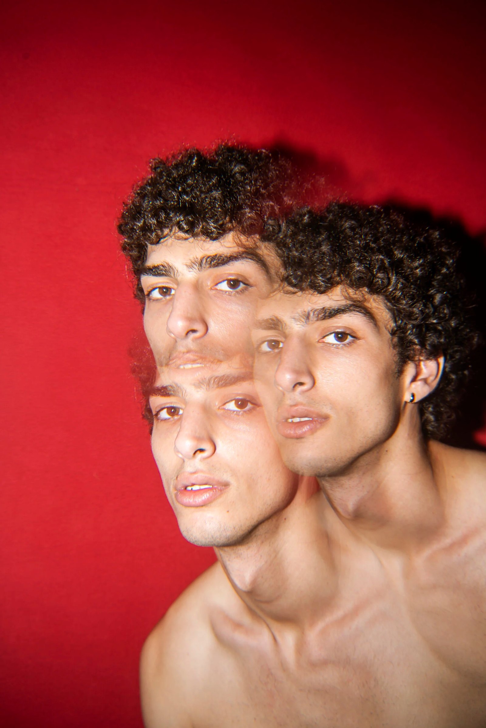 Overlapping portrait of Qaher against a saturated red background