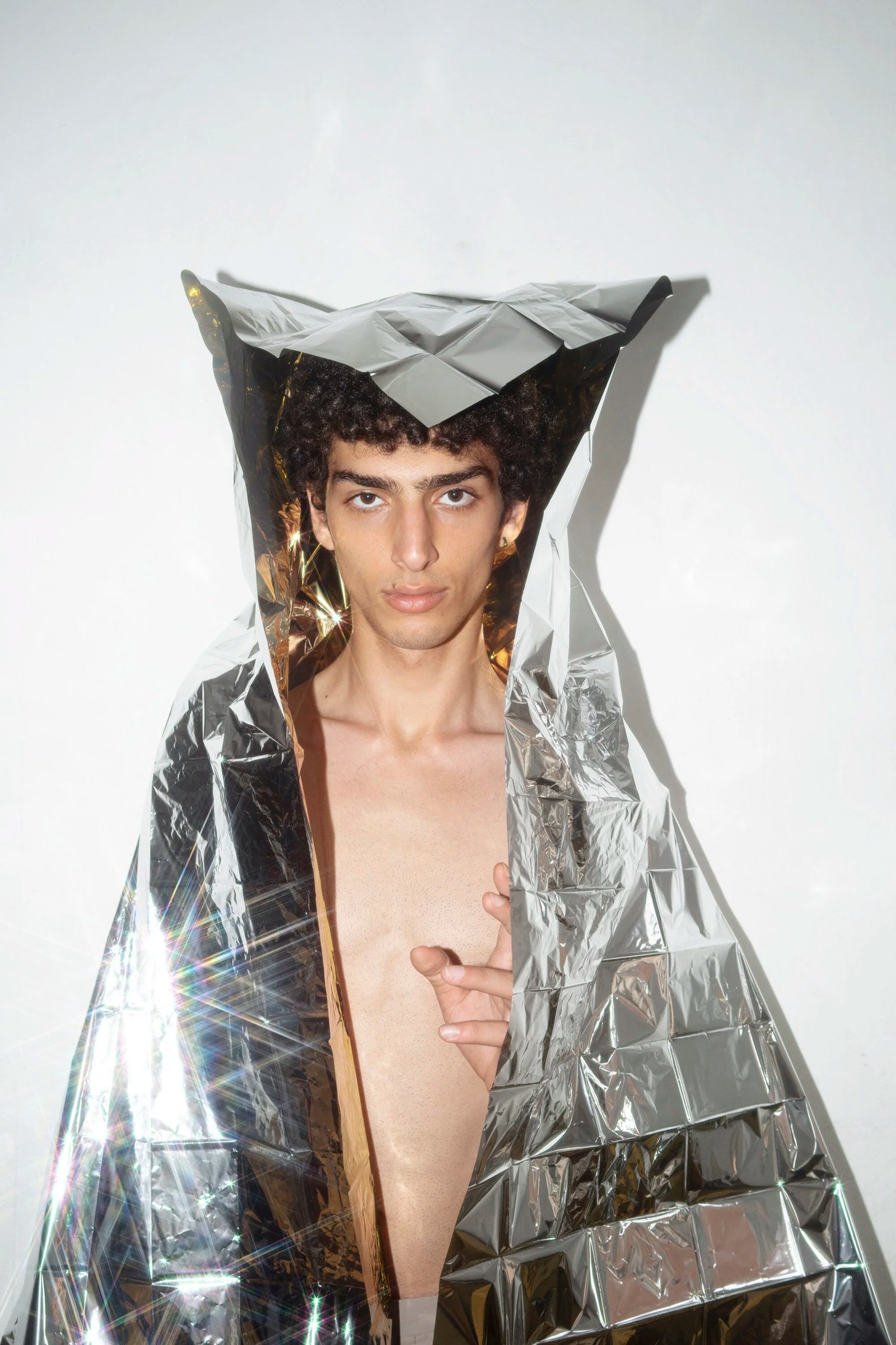 Qaher wrapped in angular reflective silver material