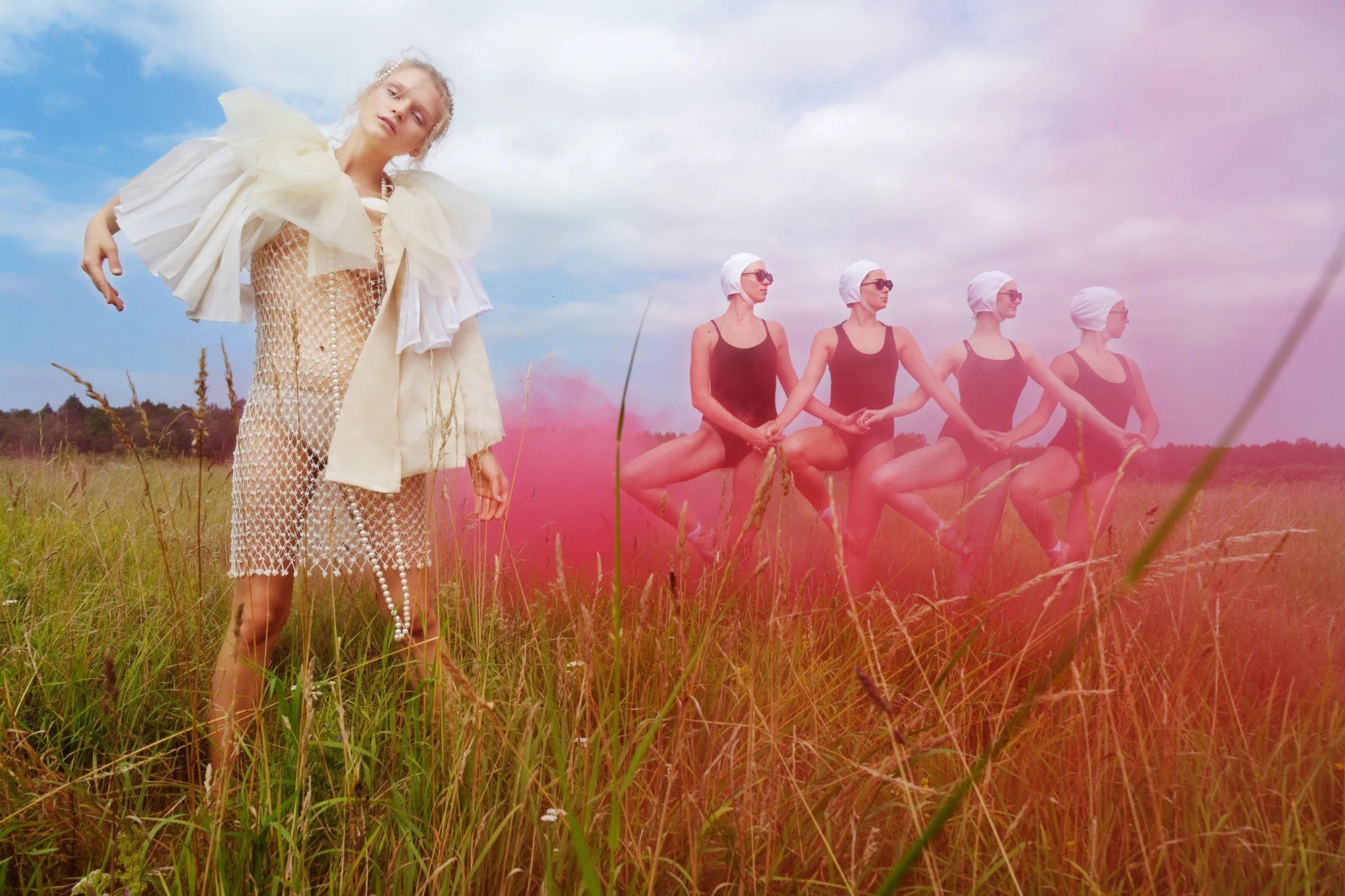 Figures in a meadow surrounded by pink haze