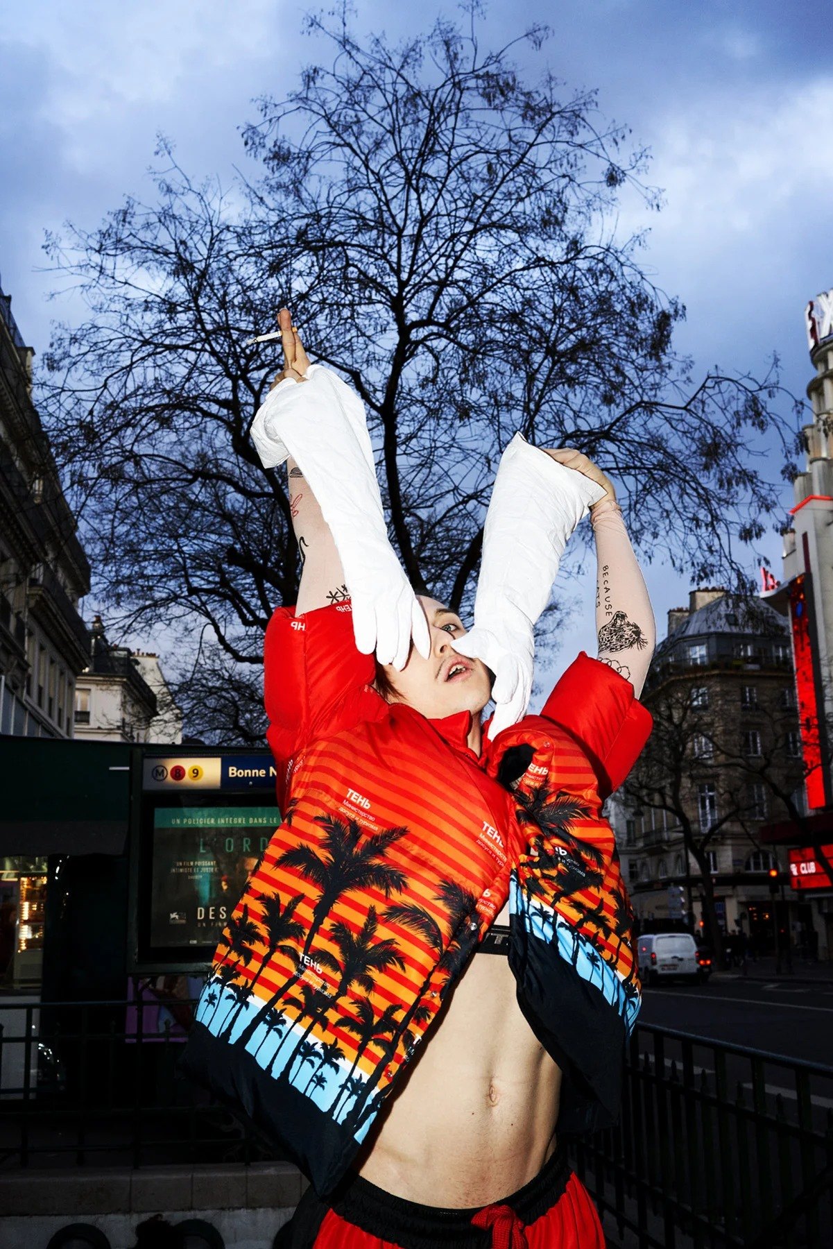 Tommy Cash posing outdoors with arms raised