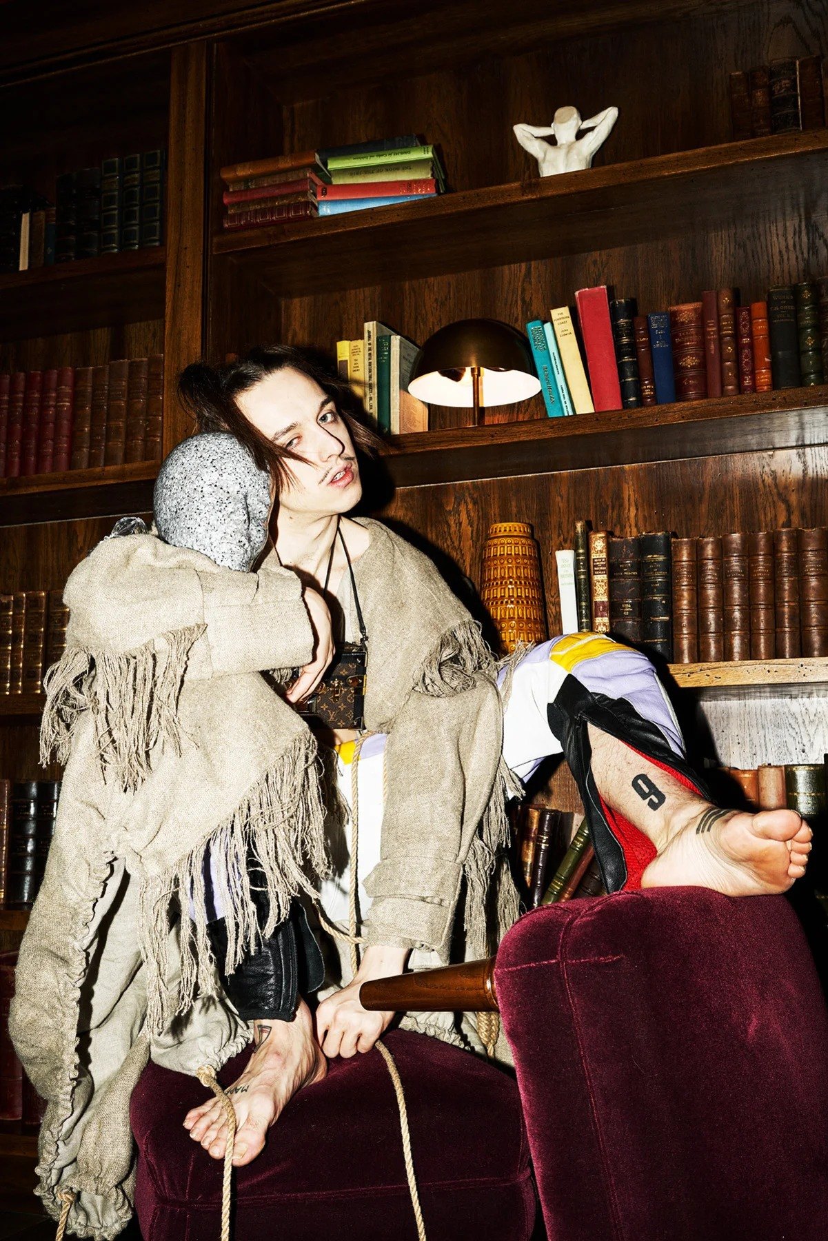Tommy Cash seated in a wood-panelled interior